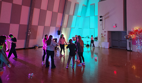 Students dance on dance floor.