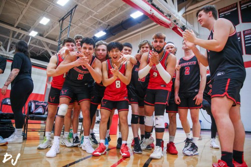 Men's athletes smile and clap together