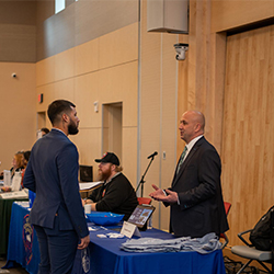 A student speaks with an employer