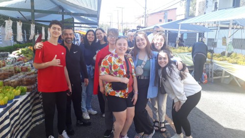 The group smiles at a public market