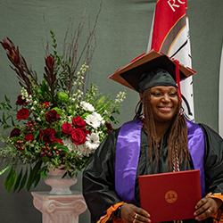 Monica Lane smiles with degree