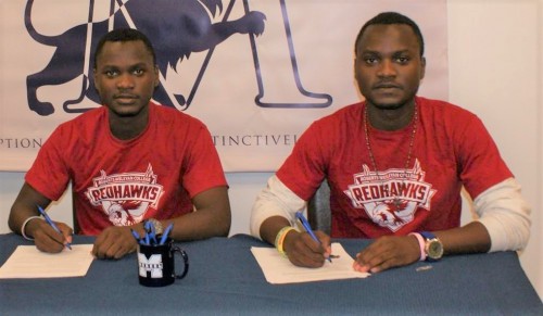 Tai and Kenny sign to Roberts in red Roberts shirts