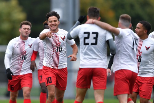 Tamas Nagy celebrates with teammates during a soccer game.