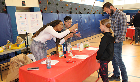Roberts students show scientific process to student and parent