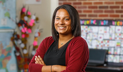 Woman smiles with arms crossed