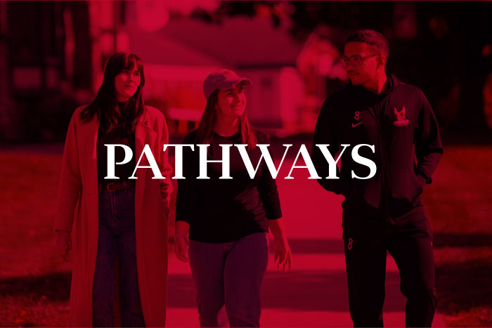 students walking down a pathway on campus