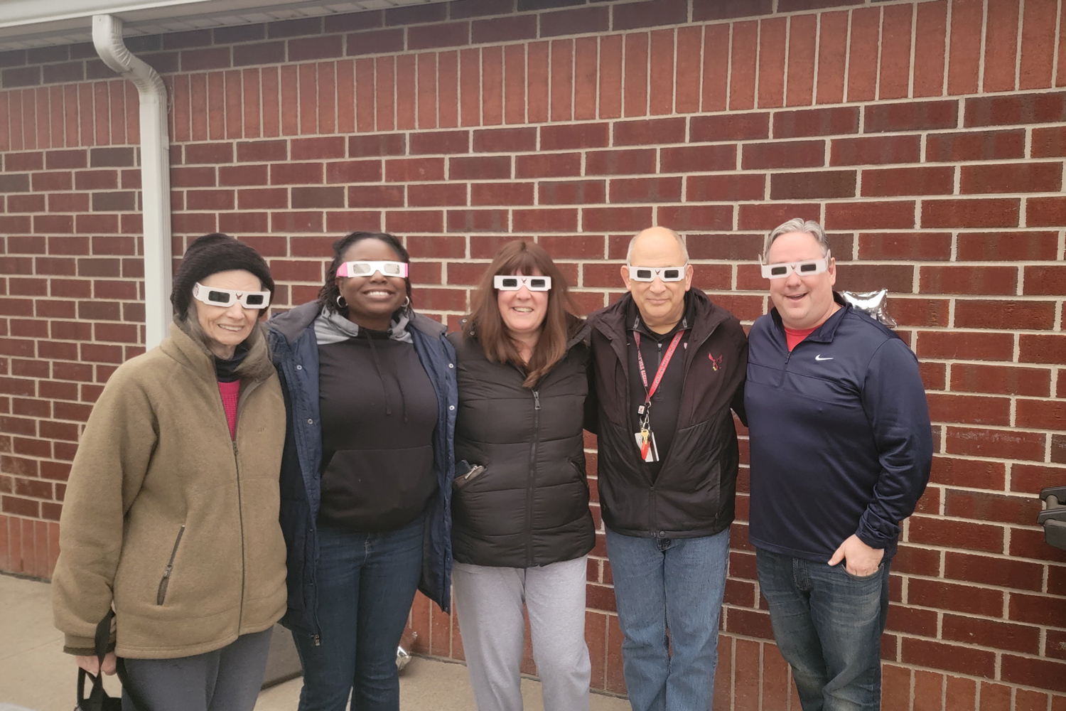 Roberts Faculty Staff and Maryann Hayles in eclipse glasses