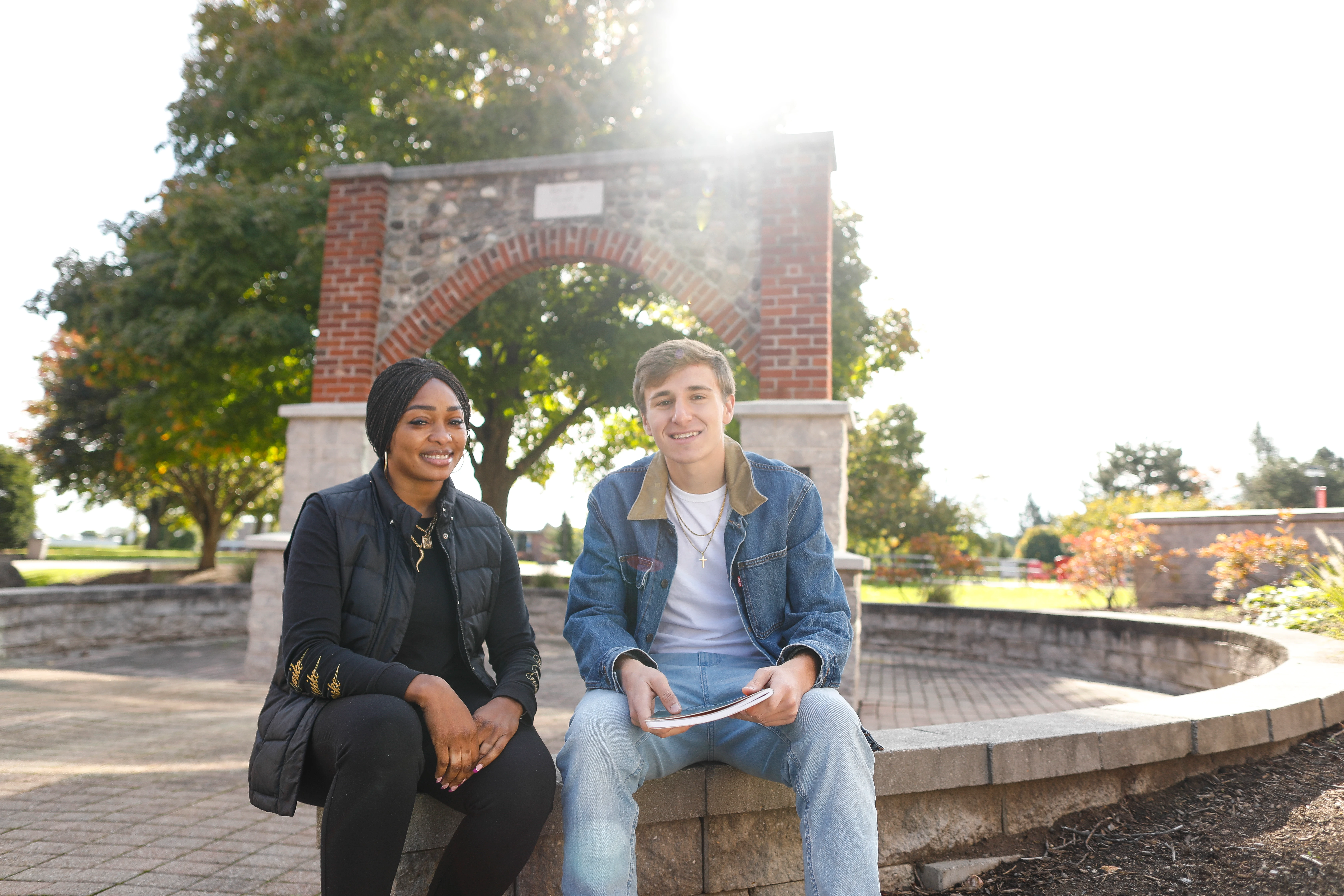 Two male and female students sit together